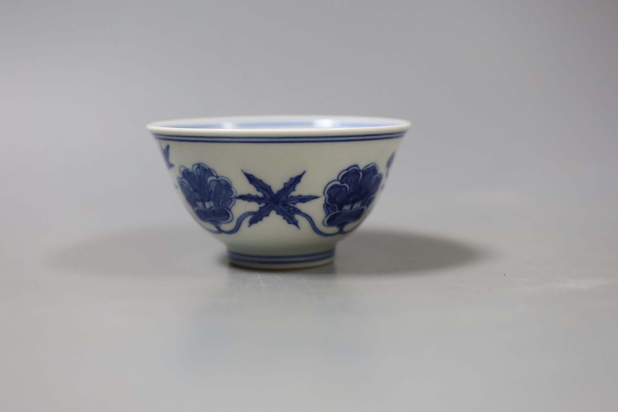 A Chinese blue and white circular bowl, inscription to base - 5cm tall